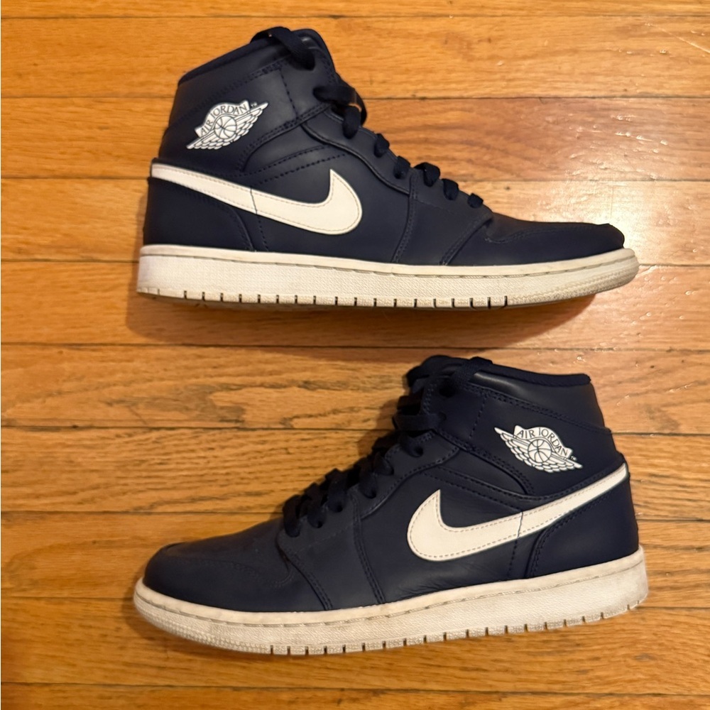 nike navy blue and white high top jordan’s
